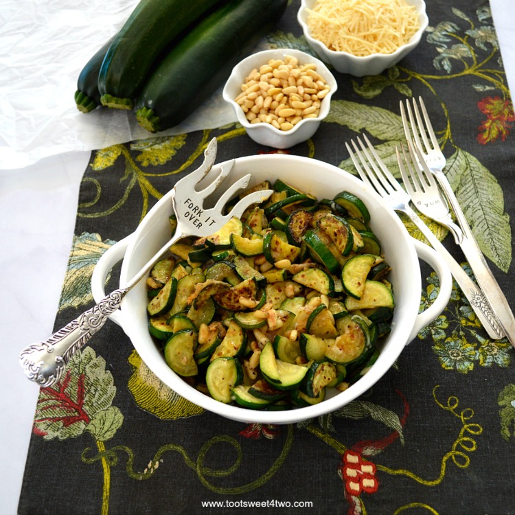 Zucchini sauteed with Parmesan and pine nuts served with a cute stamped fork - best zucchini recipes.