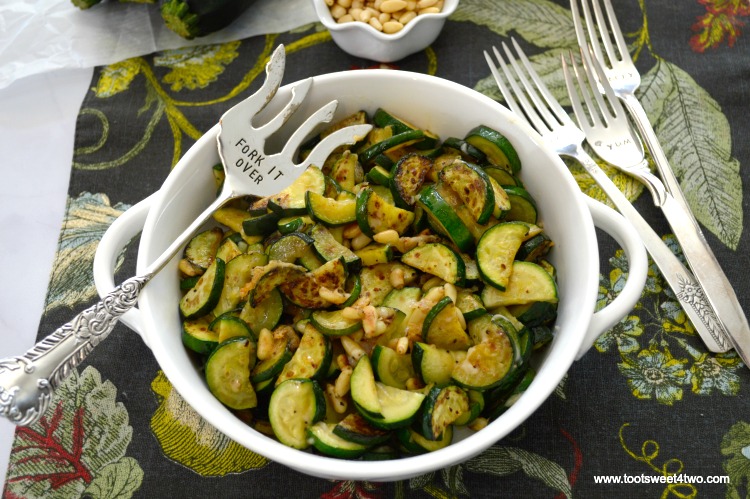 Zucchini cut into moons sauteed with Parmesan and pine nuts, one of the best zucchini recipes.