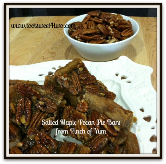 A plate full of Salted Maple Pecan Pie Bars with a bowl of pecans