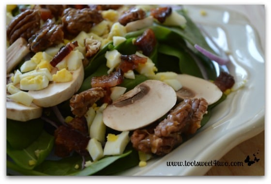 Spinach Salad with Brown Sugar Bacon and Candied Black Pepper Pecans Close-up