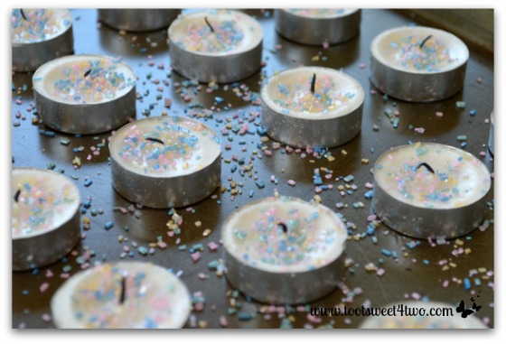Sprinkles on tea lights in melted wax