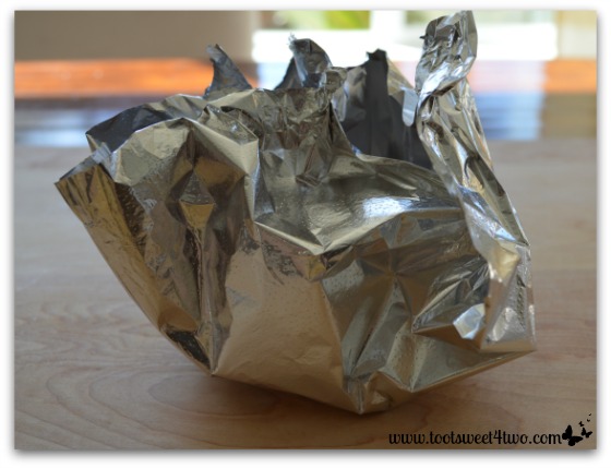 Gather 4 corners of foil for Cute and Easy Halloween Candy Packets