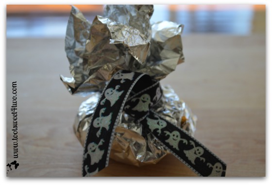 Tie ribbon around packet for Cute and Easy Halloween Candy Packets