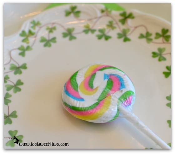 Rainbow lollipop on a shamrock plate