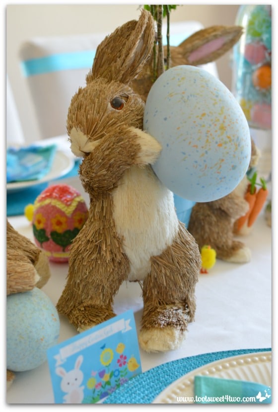 Straw Bunny holding blue egg - Decorating the Table for an Easter Celebration