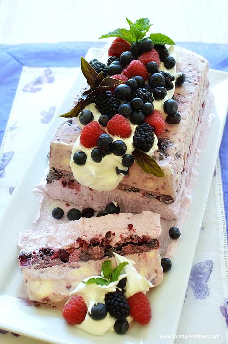 Looking for unique cheesecake recipes? Look no further! Berrylicious Ice Box Cheesecake is an easy, frozen, no bake dessert that combines an easy-to-make blackberry cheesecake layer with a layer of ice cream. Frozen for hours or overnight, unmold this luscious concoction onto a pretty platter, dollop with Cool Whip and then top with fresh blackberries, blueberries, raspberries and sprigs of mint. A spectacular-looking dessert, this delicious recipe will "wow" friends and family. | www.tootsweet4two.com