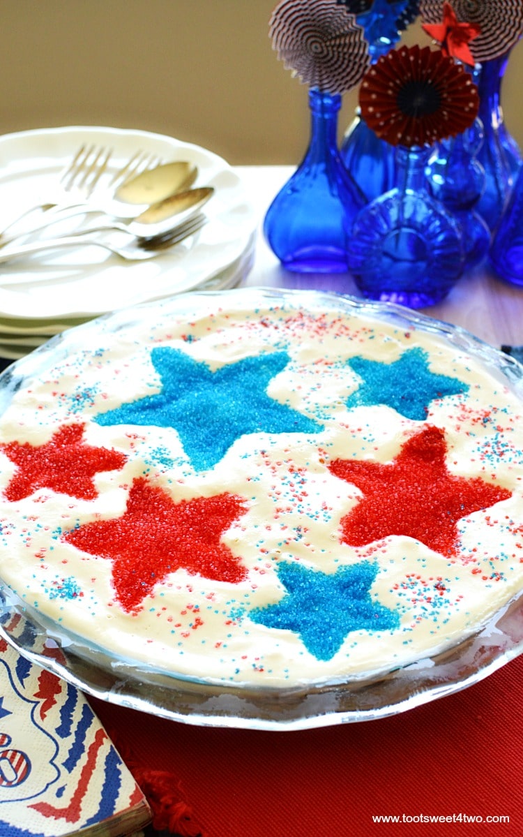 Firecracker Brownie Pie - a fun and festive 4th of July brownie recipe made with store-bought chocolate fudge brownie mix. Jarred hot fudge topping, vanilla ice cream and a surprise ingredient make this easy Independence Day dessert worthy of any Patriotic party celebration! Add sparkly red and blue stars by using various size star-shaped cookie cutters! | www.tootsweet4two.com