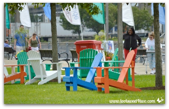Adirondack chairs and visitors at Canalside