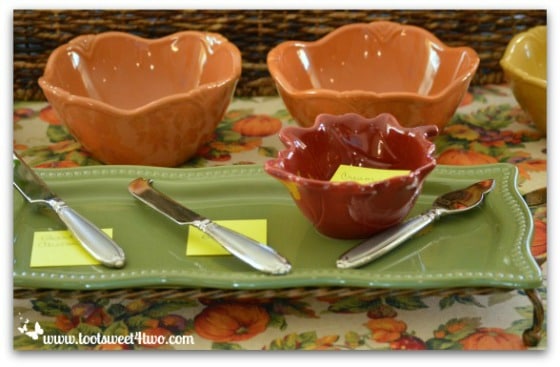 Autumn colored appetizer platter and dishes on serving table