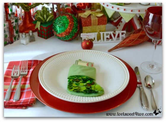 Christmas table place setting with green Christmas stocking