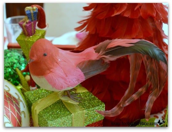 Red feathered bird on Christmas table