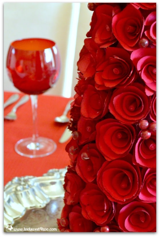 Close-up of red rose-covered tree centerpiece