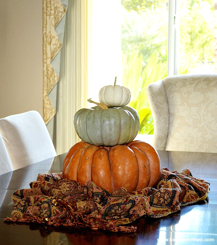 Cinderella pumpkin, Jarrahdale pumpkin, Baby Boo pumpkin stacked on dining room table