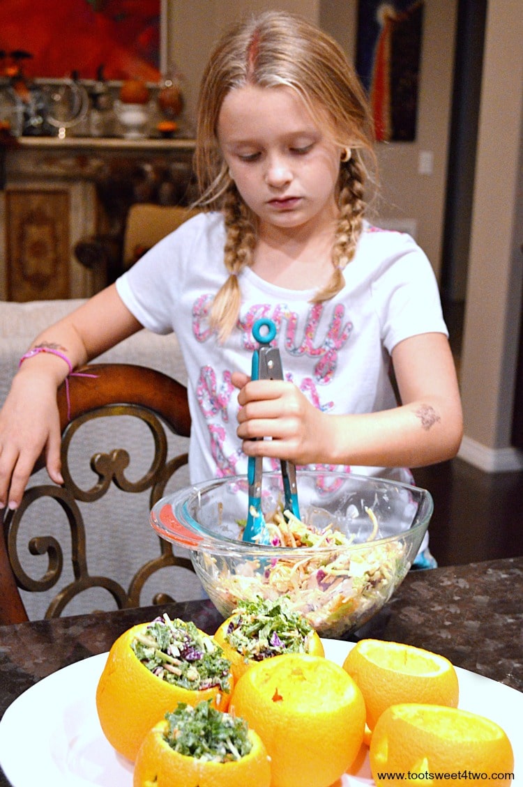 Princess P mixing salad for Easy Jack-O-Lantern Salad Cups