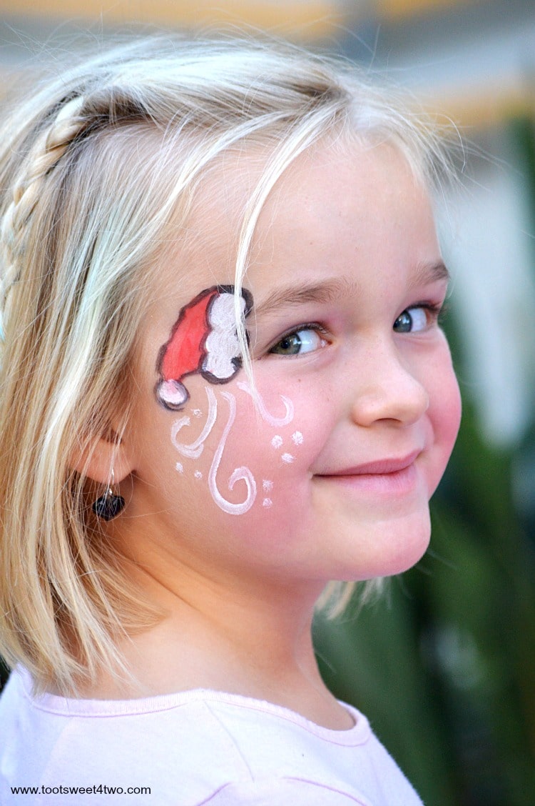 Princess Sweetie Pie with Santa hat face-painting