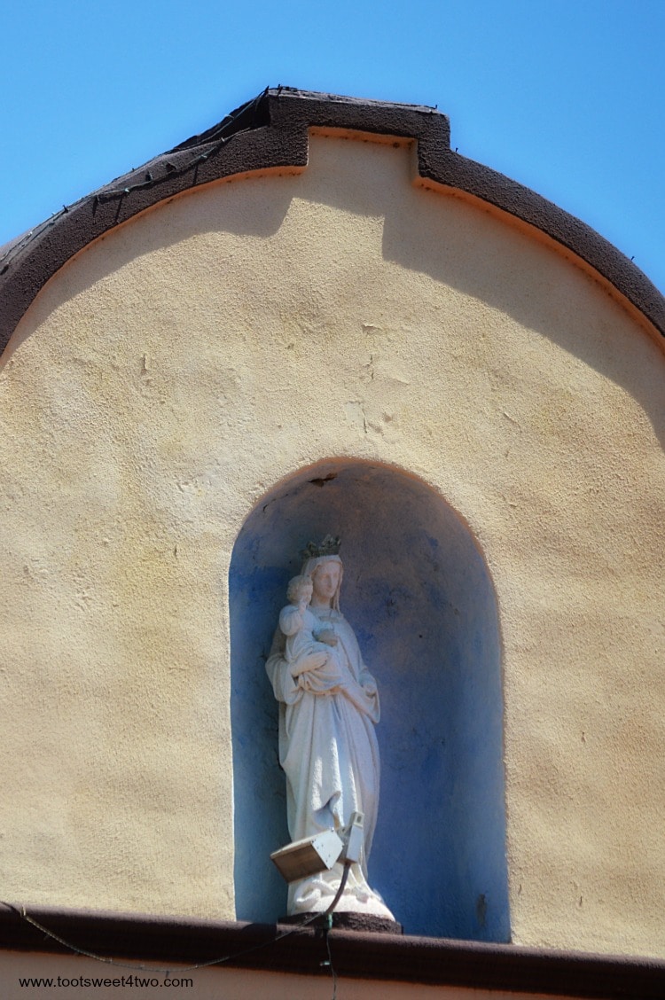 Madonna and Child sculpture in building at Old Mission San Luis Rey Gardens