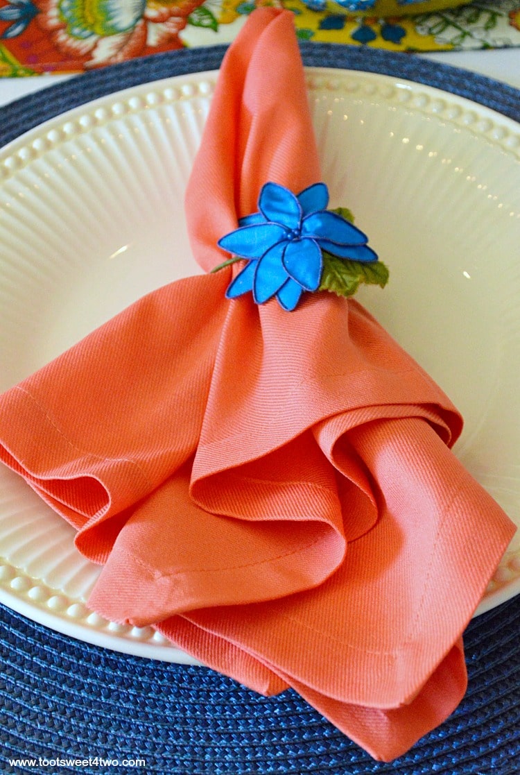 Peach napkin and blue flower napkin ring for Decorating the Table for a Cinco de Mayo Celebration