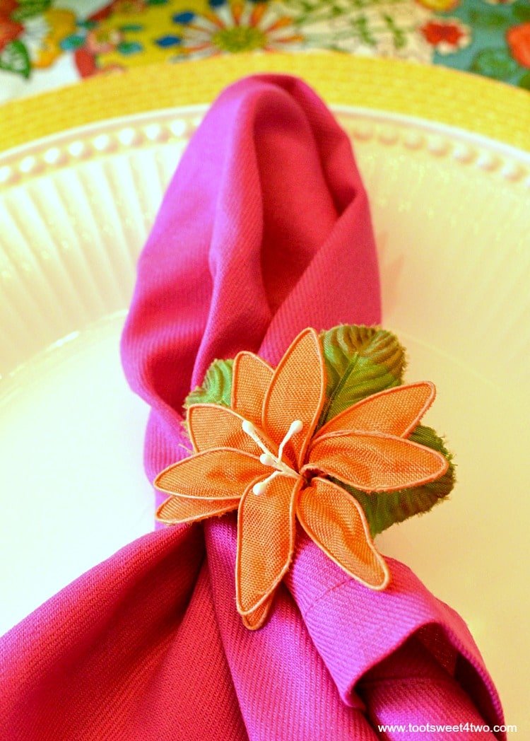 Pink napkin and orange flower napkin ring for Decorating the Table for a Cinco de Mayo Celebration