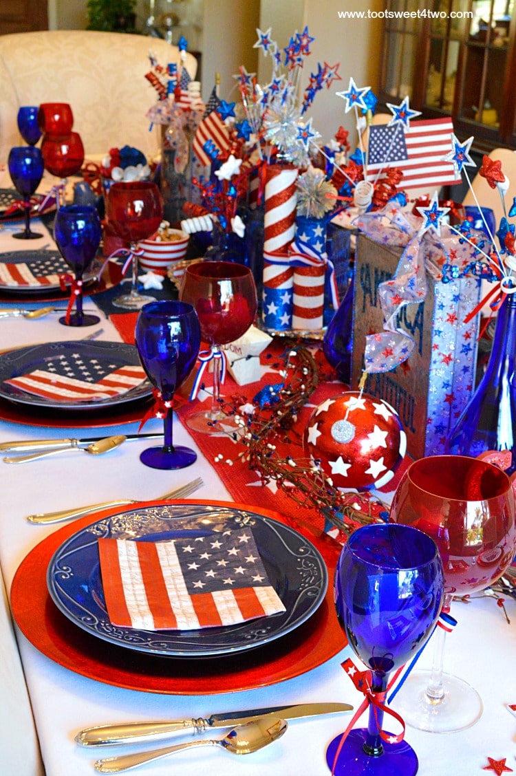 Decorating the table for a 4th of July party? Decked out in red, white and blue, this table scape has a Patriotic centerpiece mimicing fireworks with stars and stripes galore. Check out the decorations and ideas for your Independence Day celebration at www.tootsweet4two.com.