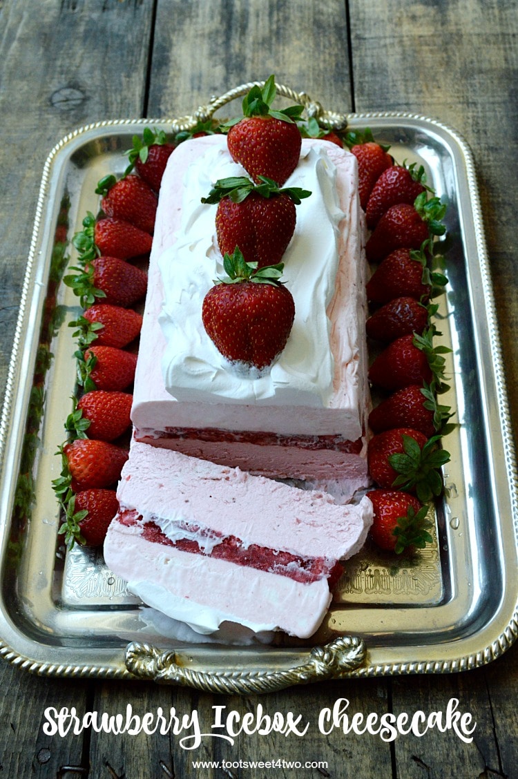 Looking for unique cheesecake recipes? Look no further! Strawberry Icebox Cheesecake is an easy, frozen, no bake strawberry cheesecake dessert that combines an easy-to-make strawberry cheesecake layer with a layer of strawberry cheesecake ice cream. Frozen for hours or overnight, unmold this luscious concoction onto a pretty platter, dollop with Cool Whip and then top with fresh strawberries. A spectacular-looking dessert, this delicious recipe will "wow" friends and family. | www.tootsweet4two.com