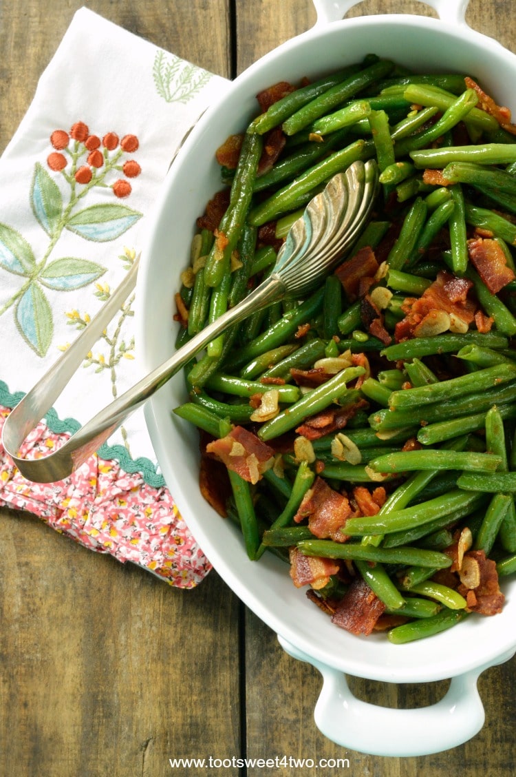 The very best fresh string beans are sauteed in a puddle of bacon grease with slivers of garlic to make a deliciously decadent side dish to accompany any main dish. Bacon Lovers' Garlic-Kissed Fresh String Beans are easy to prepare; have your kids help break the long string beans in half. Can you think of a better way to eat your veggies? | www.tootsweet4two.com