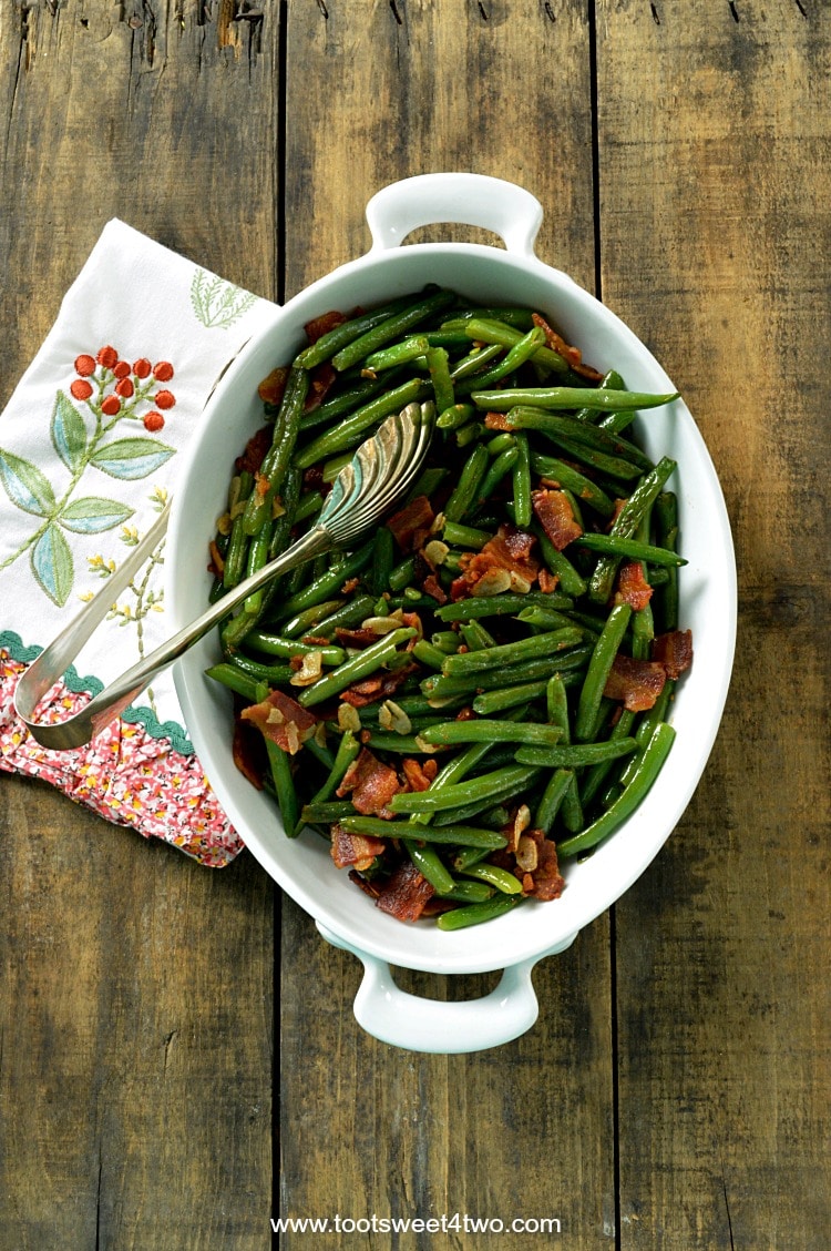 The very best fresh string beans are sauteed in a puddle of bacon grease with slivers of garlic to make a deliciously decadent side dish to accompany any main dish. Bacon Lovers' Garlic-Kissed String Beans are easy to prepare; have your kids help break the long string beans in half. Can you think of a better way to eat your veggies? | www.tootsweet4two.com