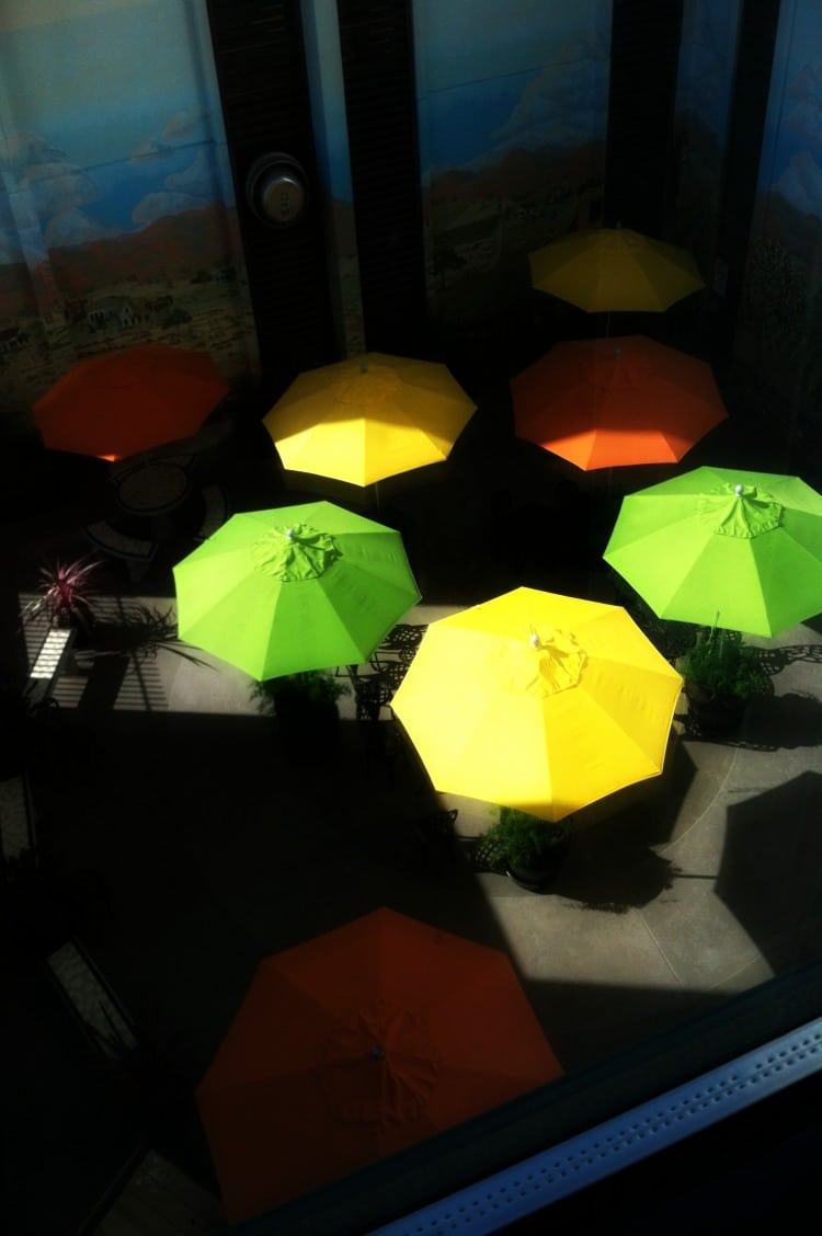 Colorful outdoor umbrellas seen from a balcony